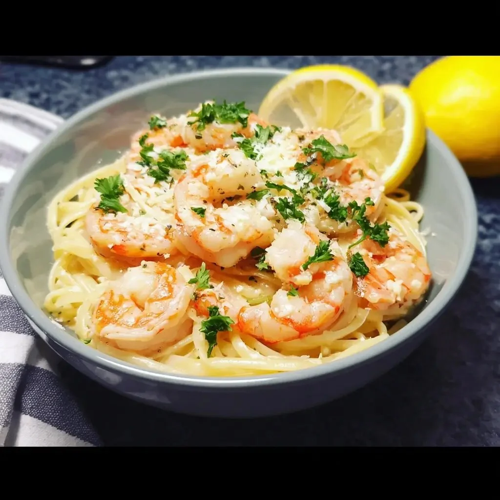 Instant Pot shrimp scampi served with pasta and parsley garnish.