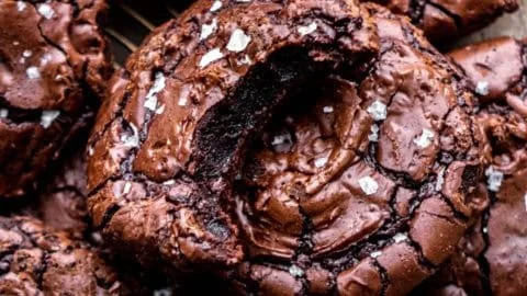 Delicious brownie cookies with chocolate chunks on a baking tray.
