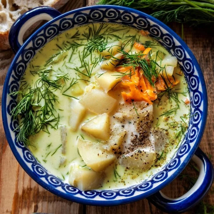 Bowl of creamy potato and dill soup with fresh herbs and spices