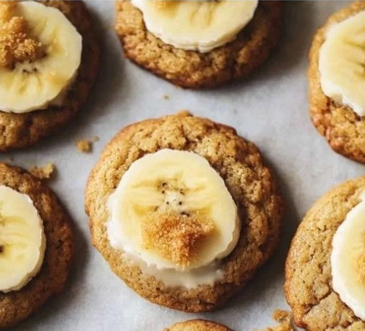 Crumbl banana bread cookies with cream cheese glaze on a plate