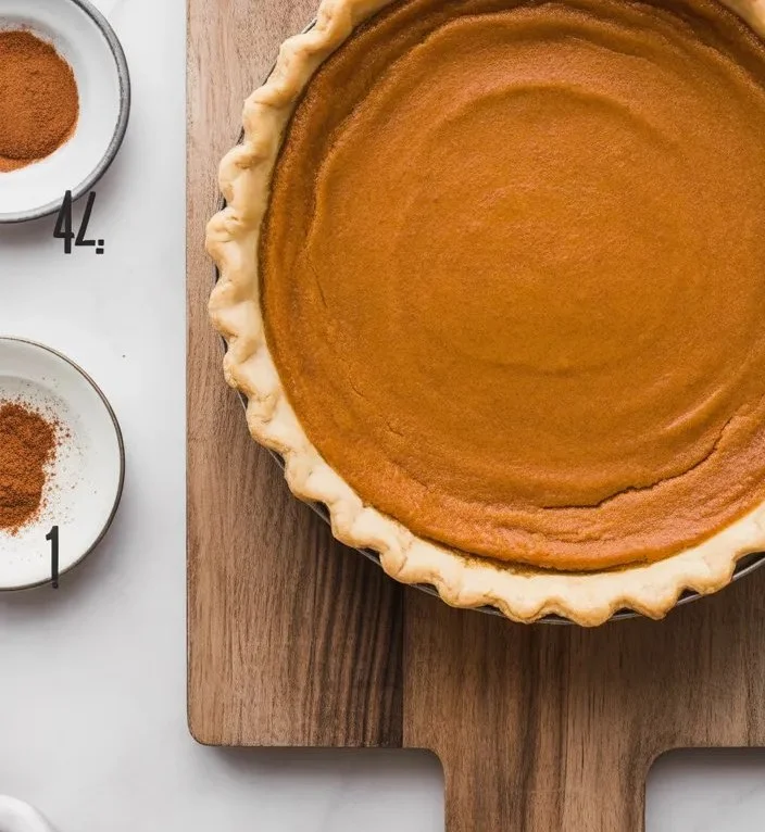 Easiest pumpkin pie with creamy filling and spice topping on a plate.
