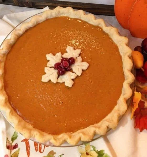 Slice of easy pumpkin pie on a plate with whipped cream