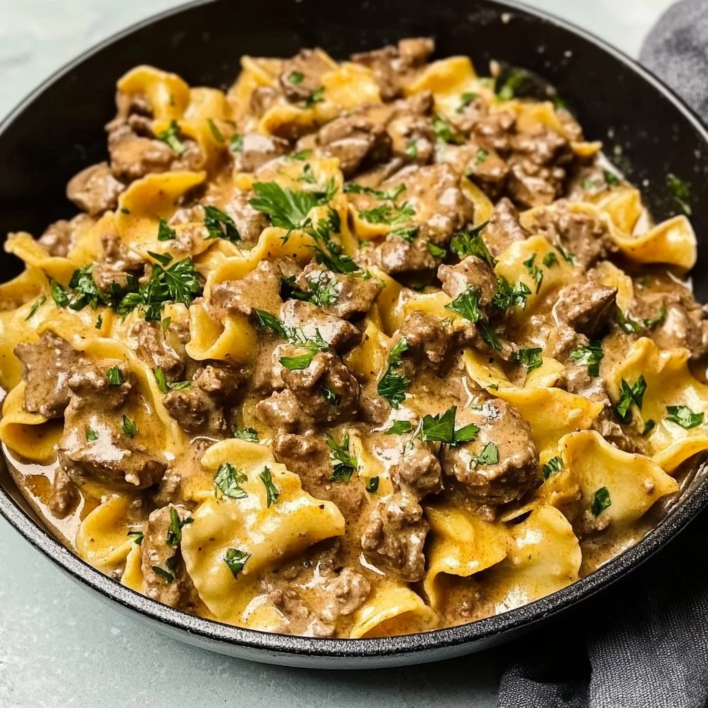 Delicious ground beef stroganoff served over noodles with creamy sauce