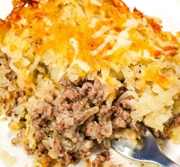 Delicious hamburger hashbrown casserole topped with melted cheese and ground beef