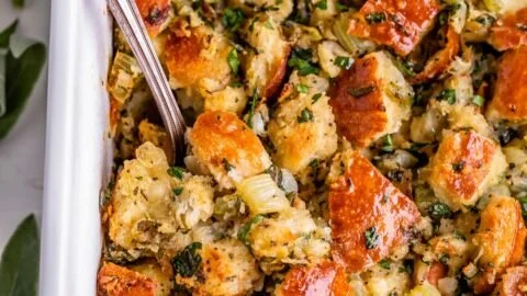 Homemade Thanksgiving stuffing with herbs and vegetables in a serving bowl