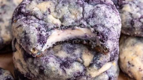 Lemon blueberry cheesecake cookies stacked on a plate