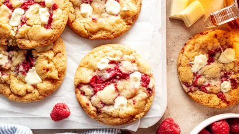 Delicious raspberry cookies with white chocolate chunks on a cooling rack.